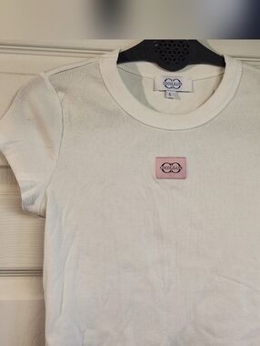Cocolilys Cropped White Ribbed Short Sleeve Tee with Pink Logo Patch